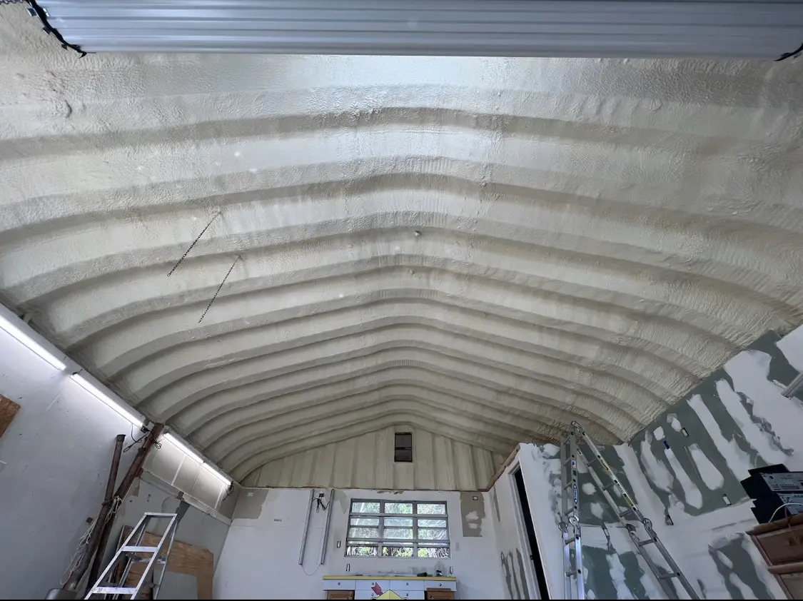 Spray polyurethane foam applied to the underside of a metal roof deck in George Mason